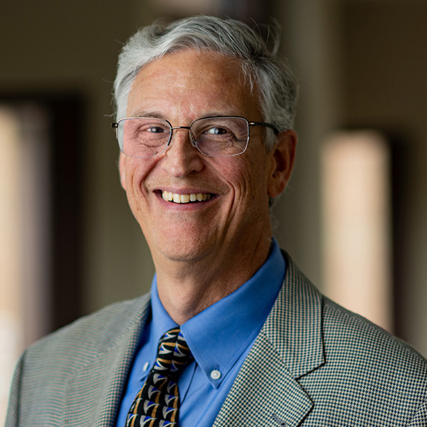 Mark Van Oyen smiles and poses for a portrait.