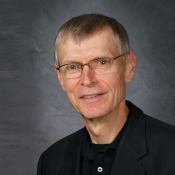 Thomas J. Armstrong smiles and poses for a portrait.