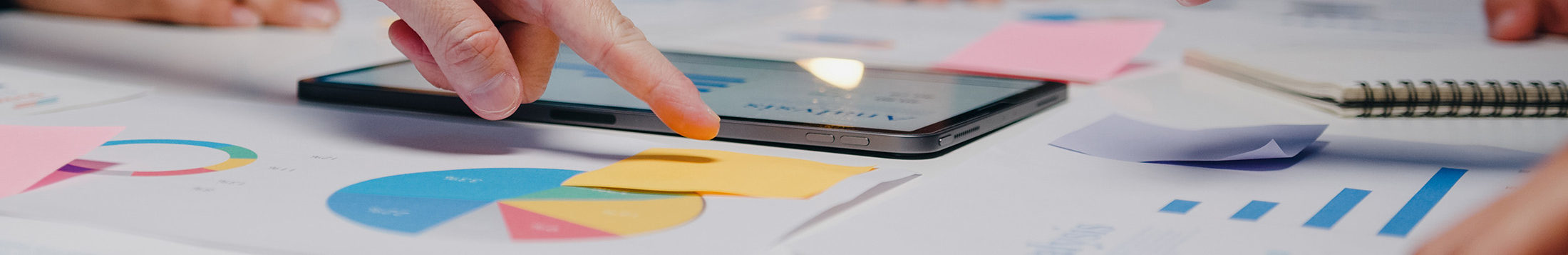 People pointing at data during a business meeting