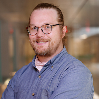 Paul Pridham smiles and poses for a portrait.