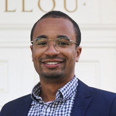 Caleb Jeanniton smiles and poses for a portrait.