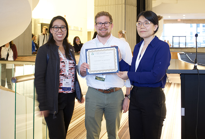 University of Michigan Human Factors and Ergonomics Society President accepts an award.