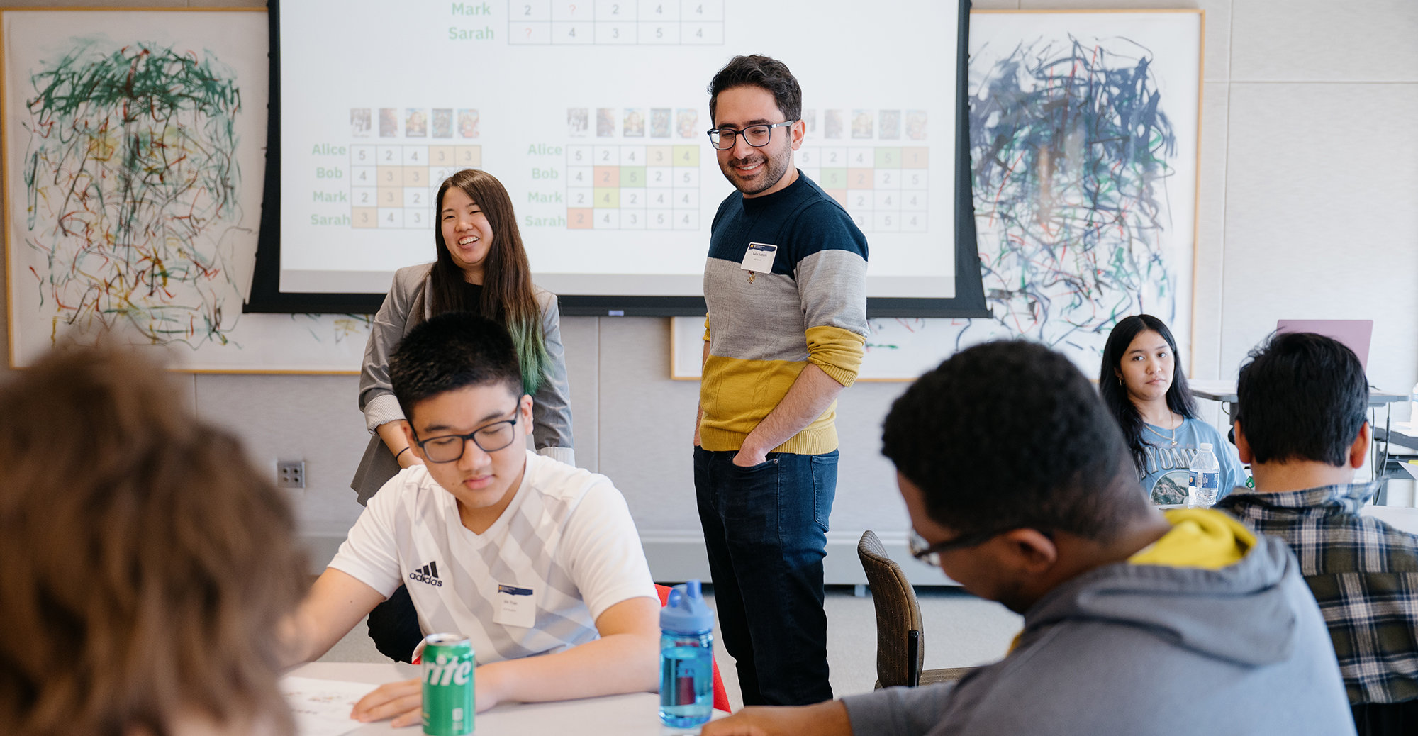 Tiffany Wu and Salar Fattahi watch as students complete an assignment