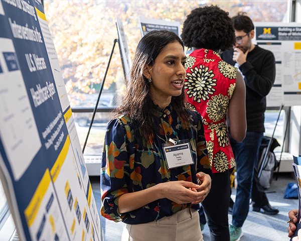 Aparna talking to an on looker about her poster