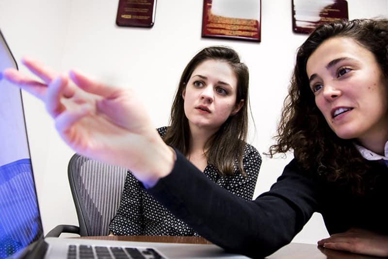 Two people looking at computer