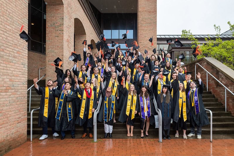 People throw graduation caps